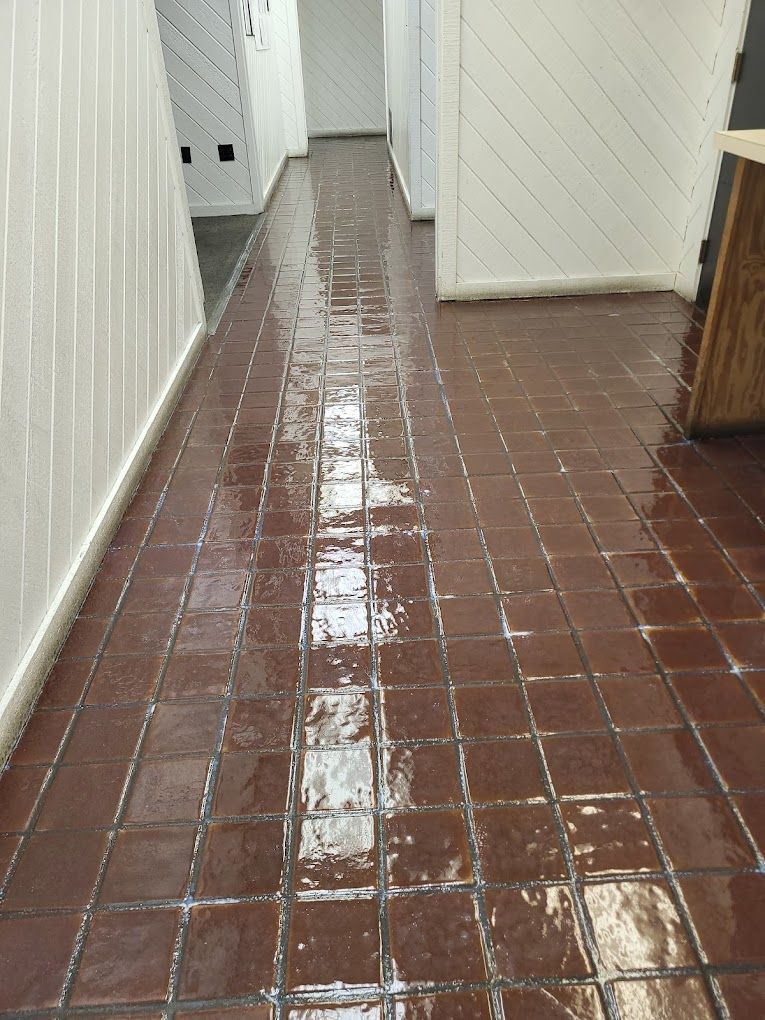 A hallway with a tiled floor and white walls