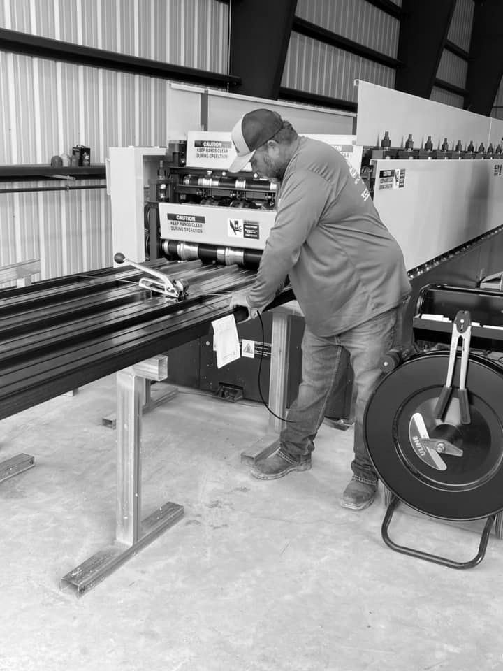 A man is working on a machine in a black and white photo.
