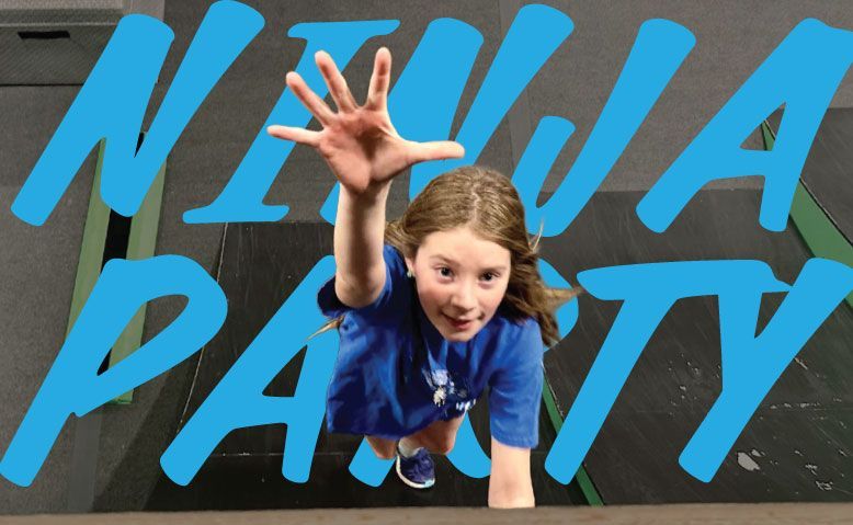 Child reaching toward camera in front of bright blue “NINJA PARTY” sign