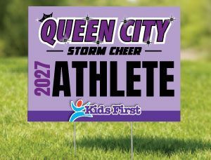 Purple yard sign reading “Queen City Storm Cheer 2027 Athlete” with Kids First logo on grass.