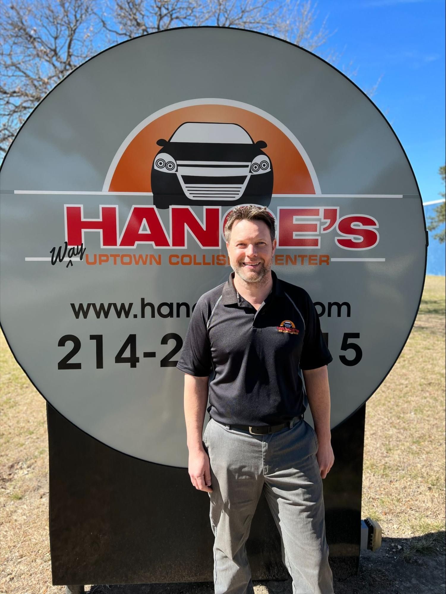 A man is standing in front of a hanes sign