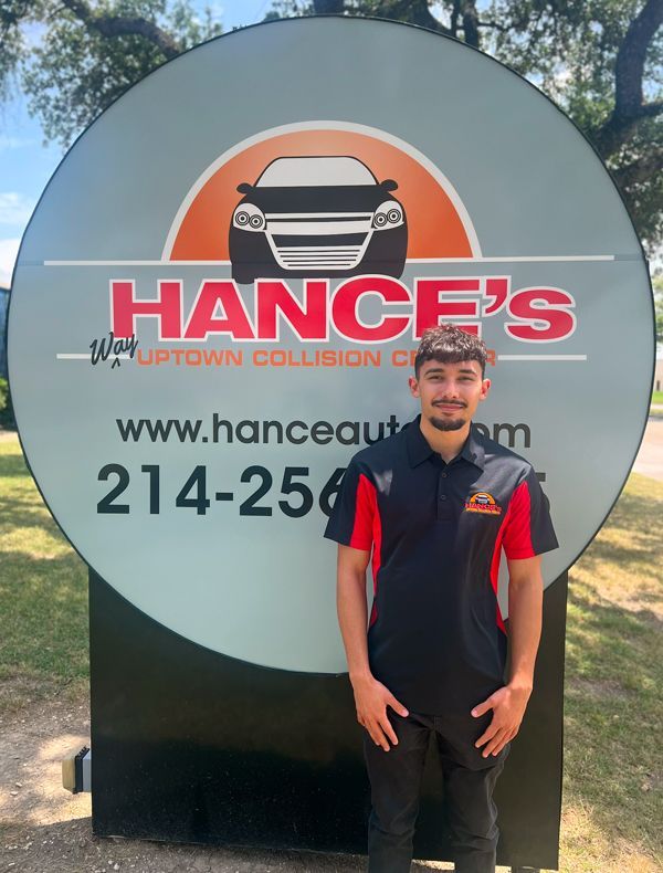 A man standing in front of a sign that says hance 's