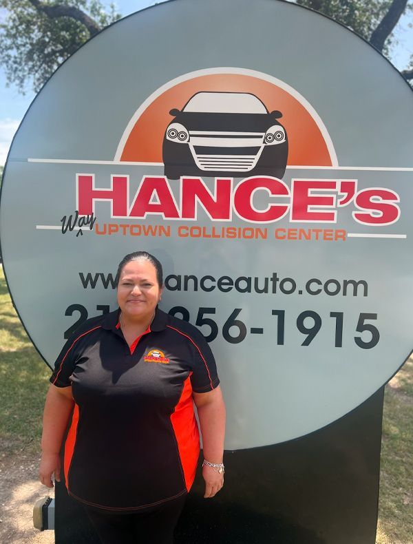A woman is standing in front of a hance 's sign