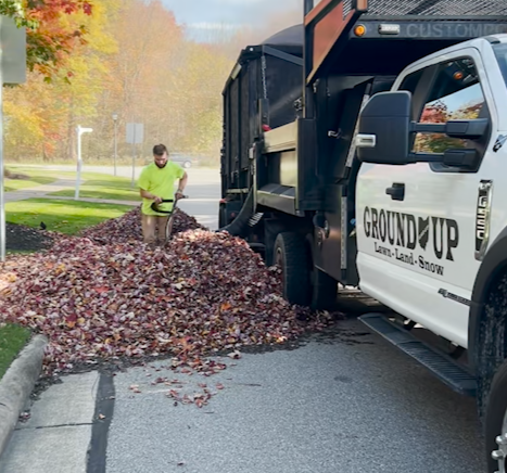 Ground Up Team Member vacuuming leaves