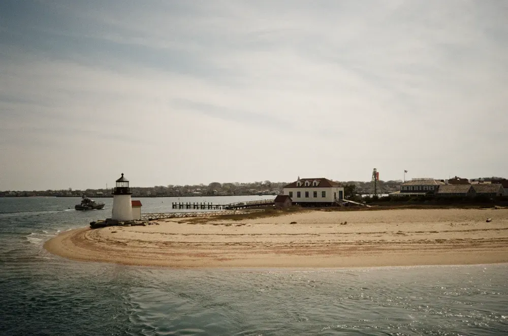 A landscape film photograph of the Brant Point lighthouse in the distance