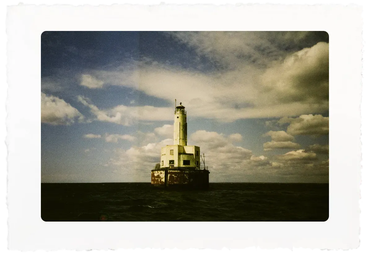 Cleveleand lighthouse on a small offshore platform beneath a cloudy sky