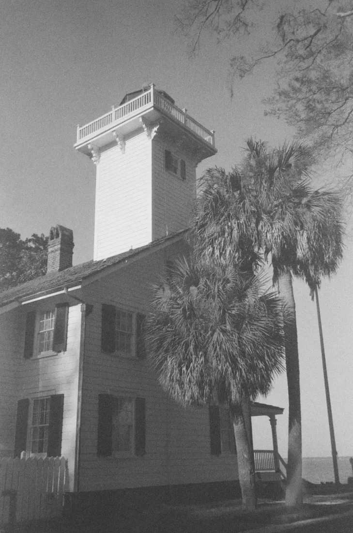 A portrait film photograph of Haig Point lighthouse in South Carolina