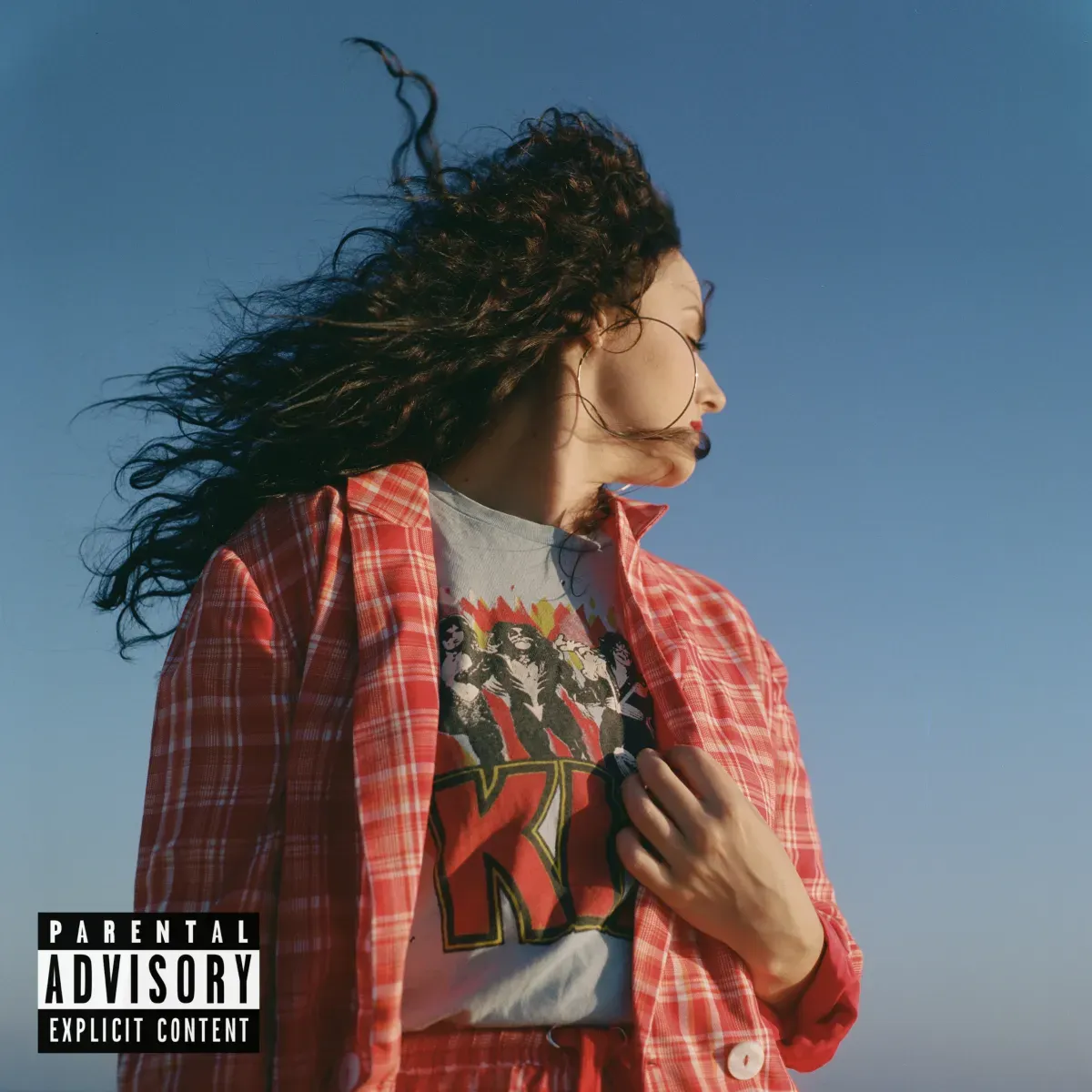 Album art for "Heaven's a Scary Place" by Charlee Remitz: Woman in red plaid jacket looking off to the side.