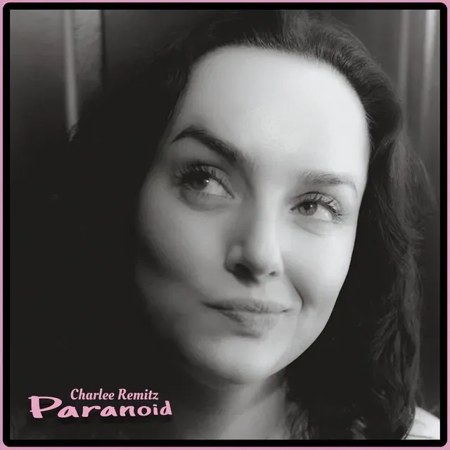 Black-and-white album cover of Charlee Remitz with a slight smile, captioned Paranoid