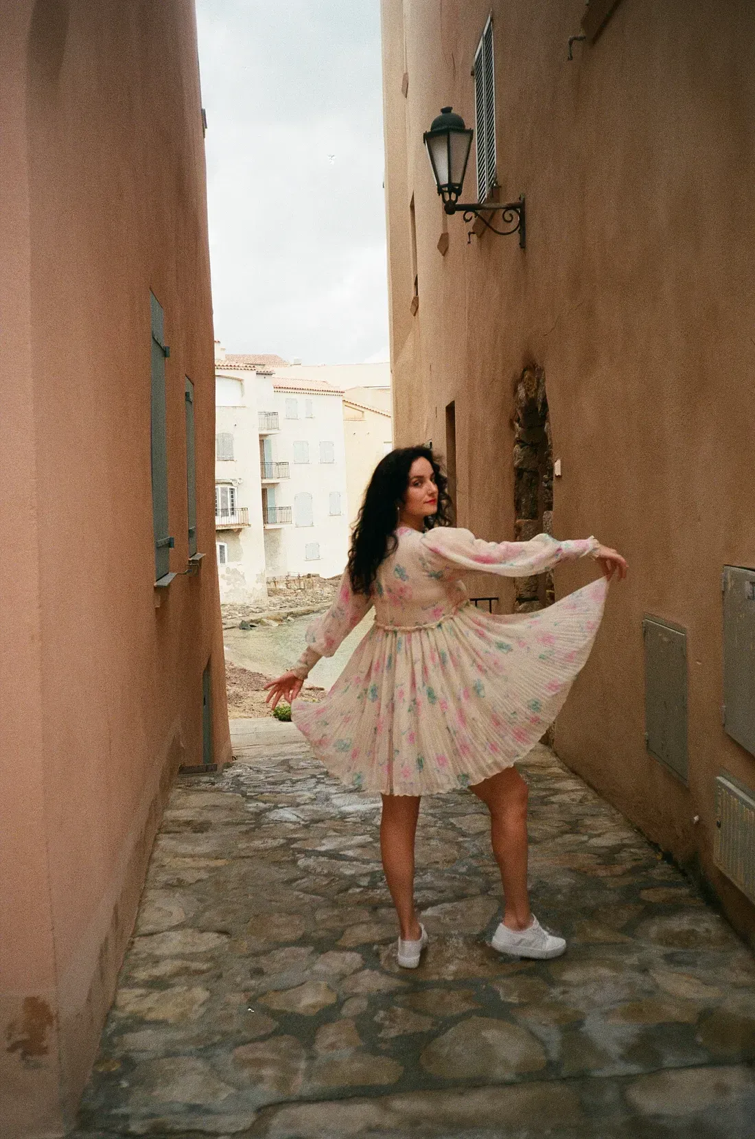 A woman in a floral pink dress in St. Tropez, 2019. Caught on 35mm