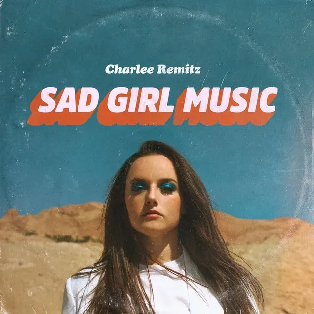 Charlee Remitz album cover: woman, sad expression, in desert setting; "Sad Girl Music" title.