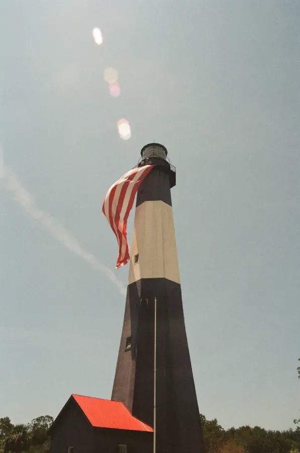 Tybee Island lighthouse with an American flag on film
