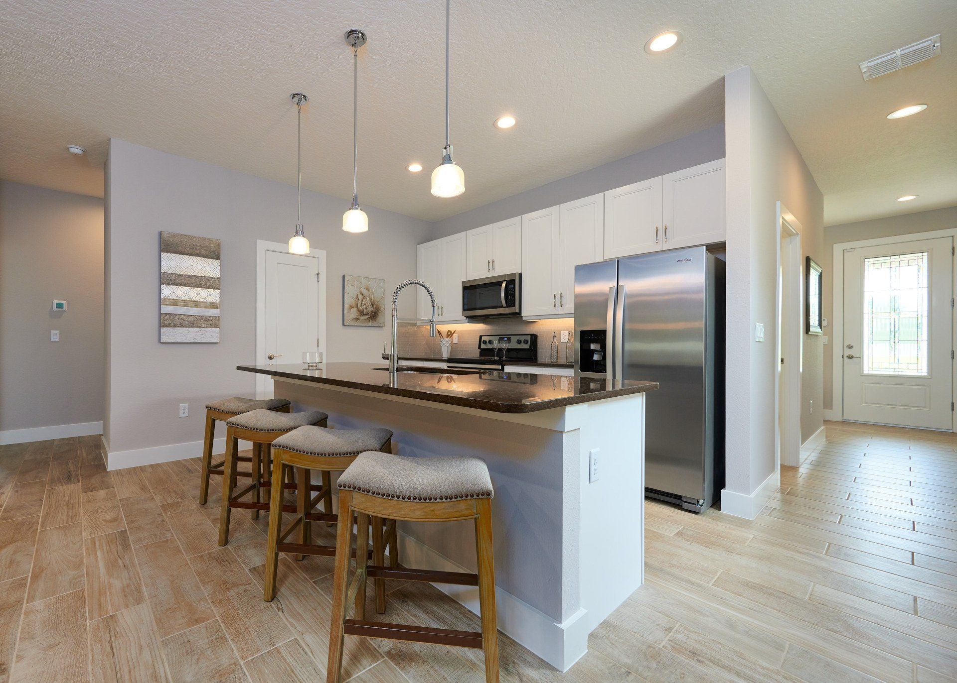 Arisha Enclave living room with neutral décor, hardwood floors, and open layout