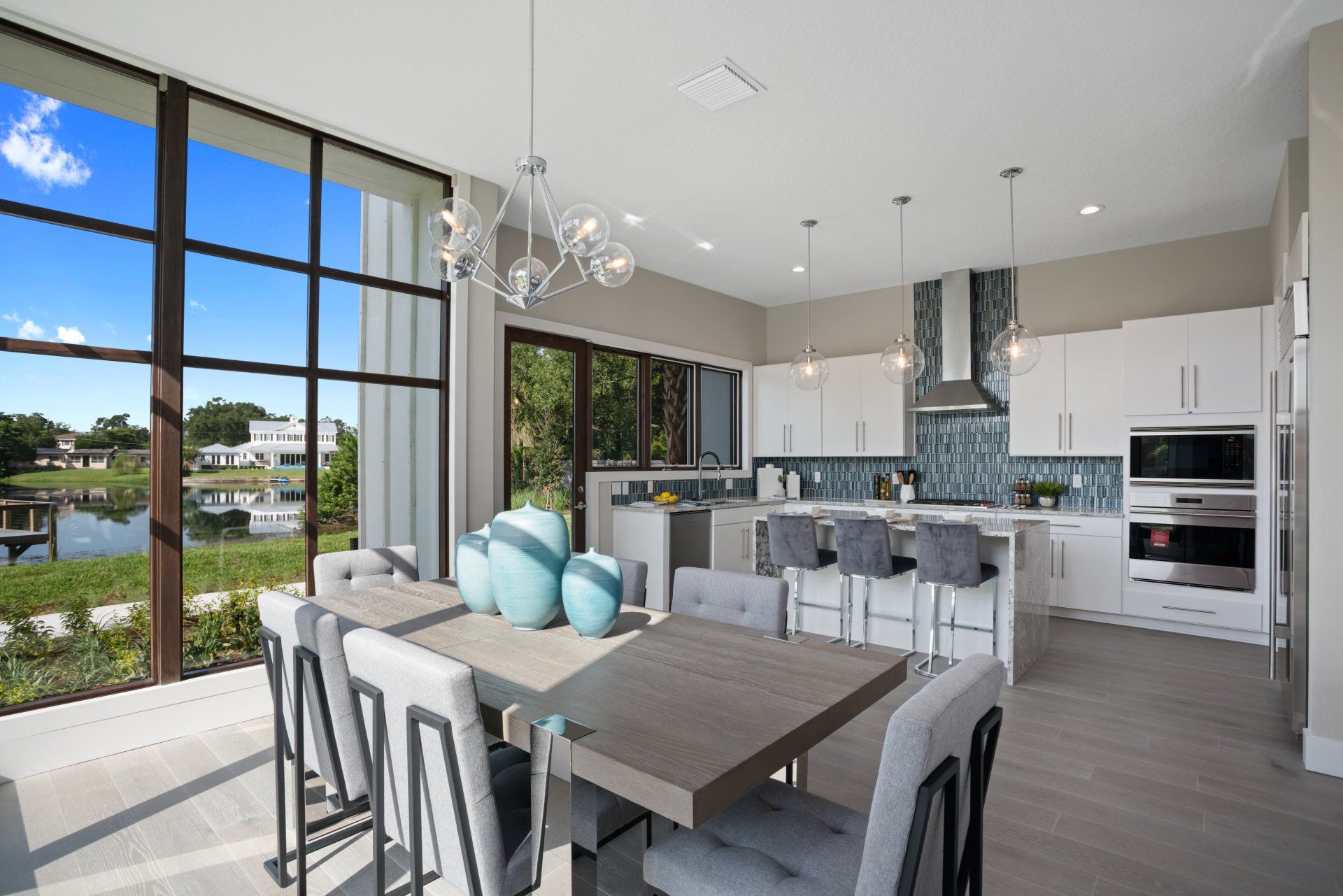Bright kitchen and living space with floor-to-ceiling windows and modern finishes.
