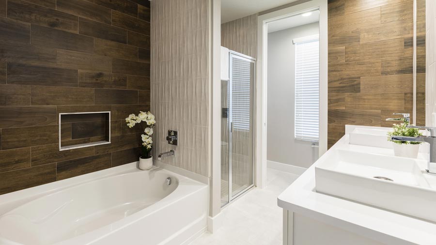 Modern bathroom at Summerville Resort featuring walk-in shower, double vanity, and wood-look tile walls.