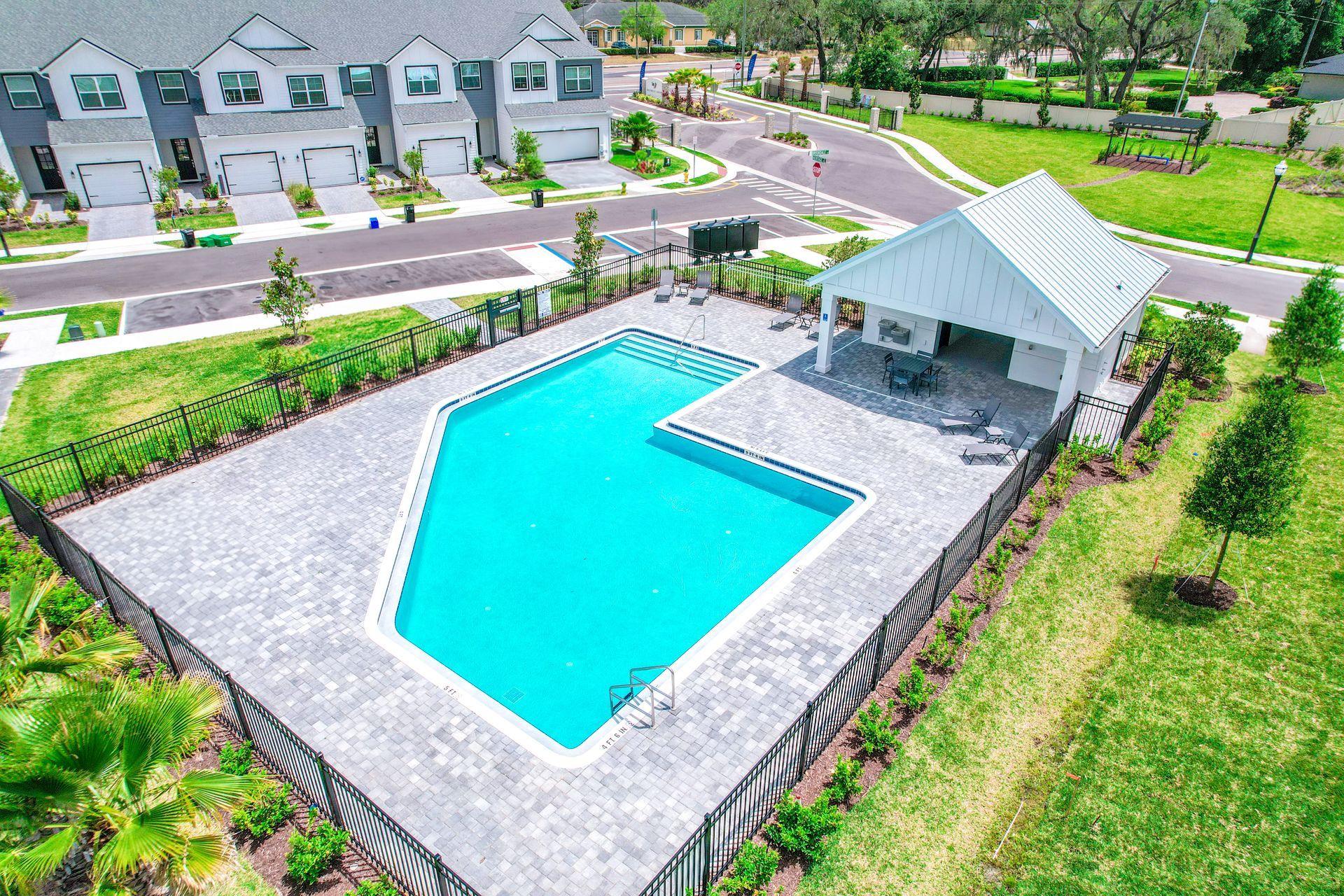 Aerial view of Brentwood Landing community featuring central pool, surrounding townhomes, and landscaped grounds