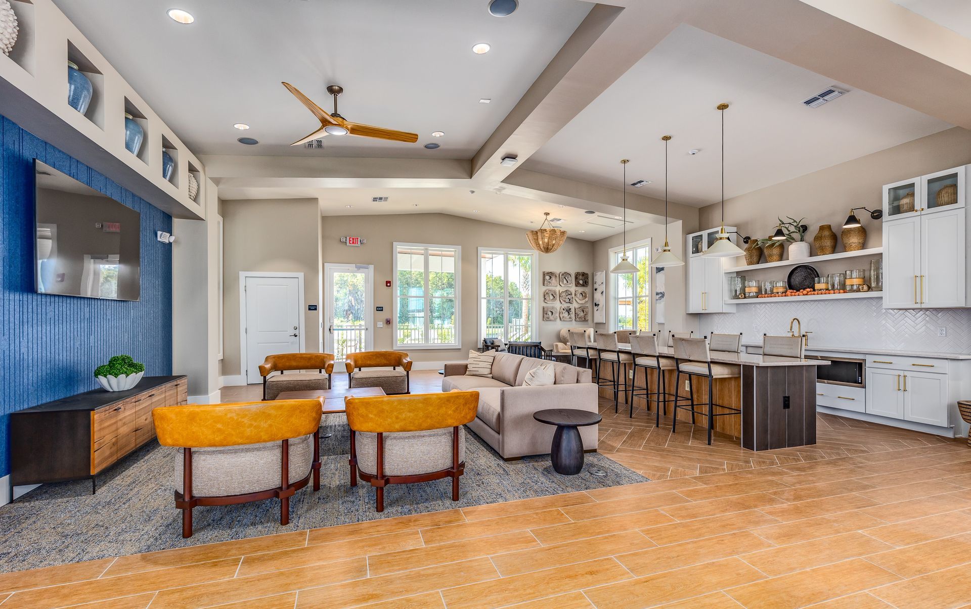 Open-concept living and kitchen space featuring island seating and modern lighting