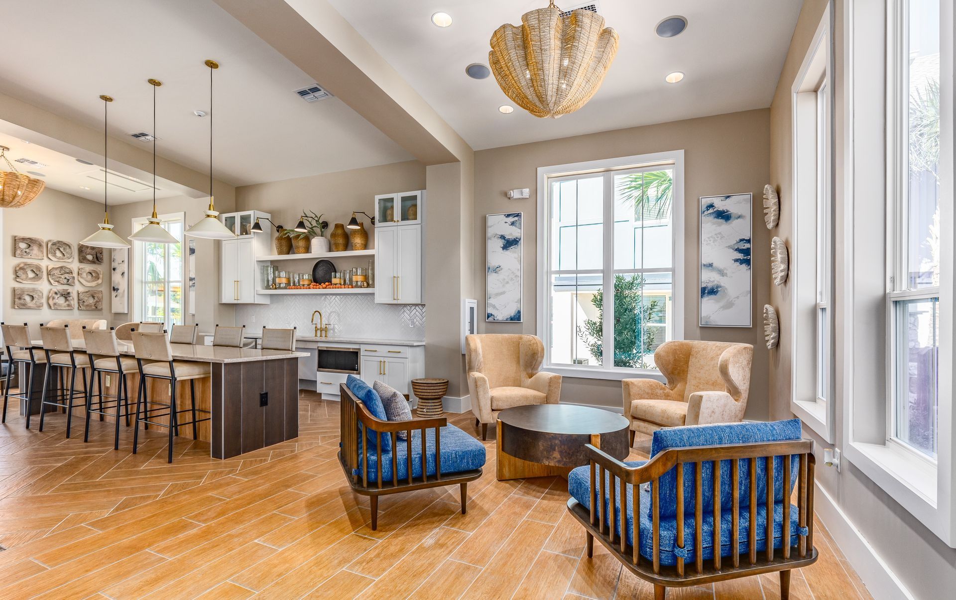Community dining room with long tables, chairs, and large windows overlooking outdoor space