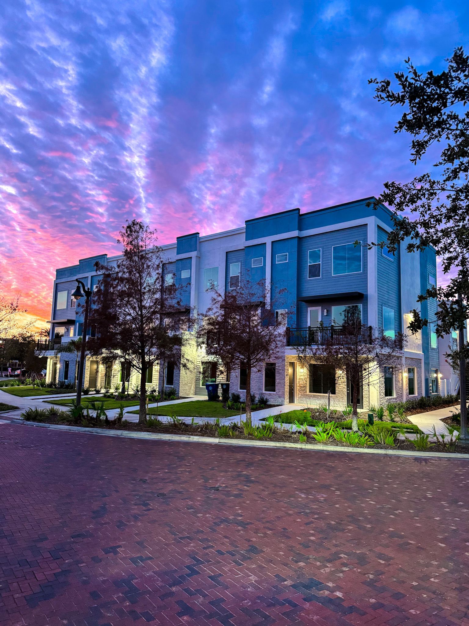 City Place townhome exterior at sunset with colorful sky and modern architecture