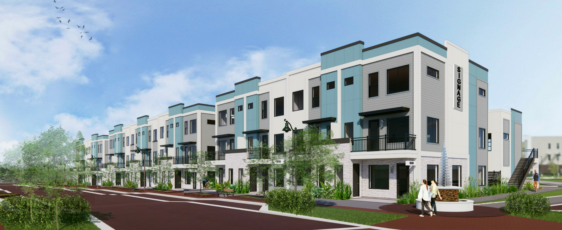 White modern luxury townhome building with balconies and landscaped surroundings