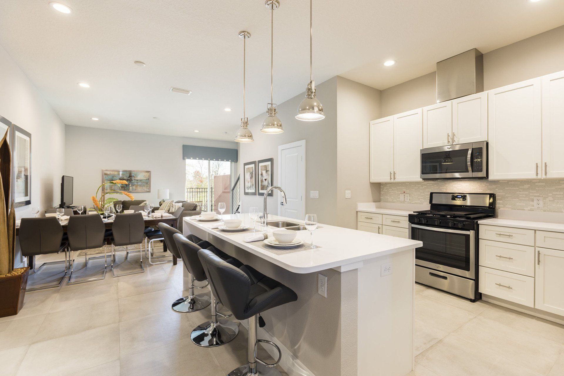 Summerville Resort kitchen with white cabinetry, stainless steel appliances, and modern lighting