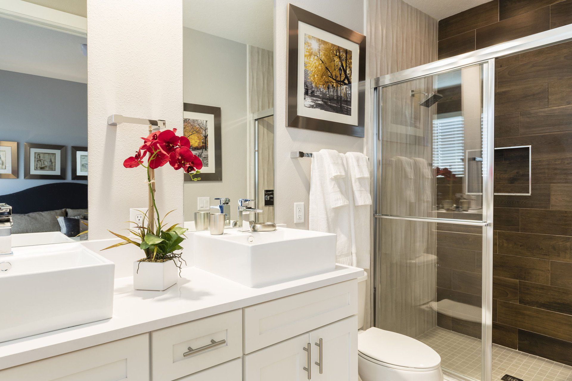 Bathroom at Summerville Resort featuring stone countertops, large mirror, and modern fixtures.
