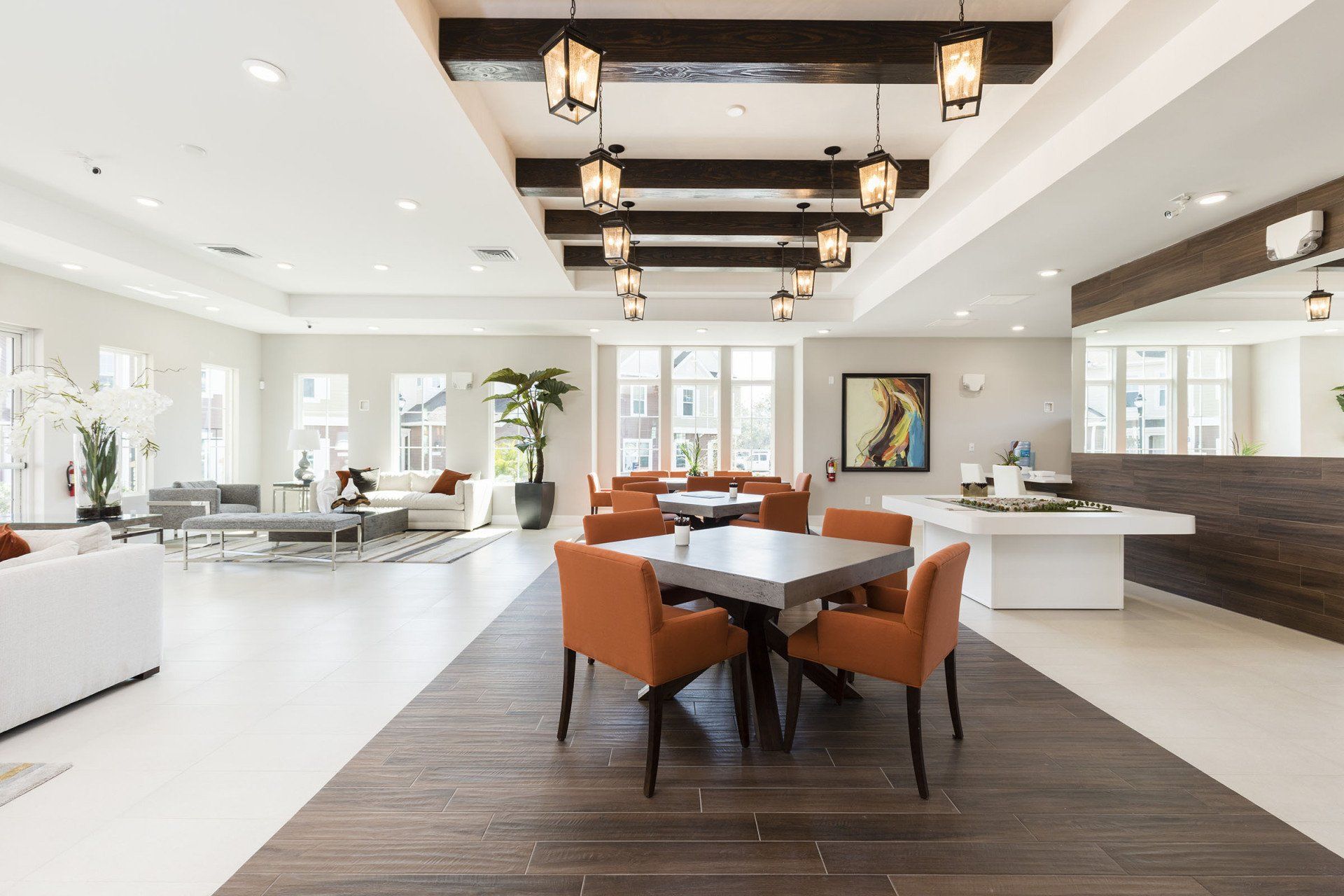 Summerville Resort clubhouse interior with lounge seating, dining tables, modern lighting, and community amenities.