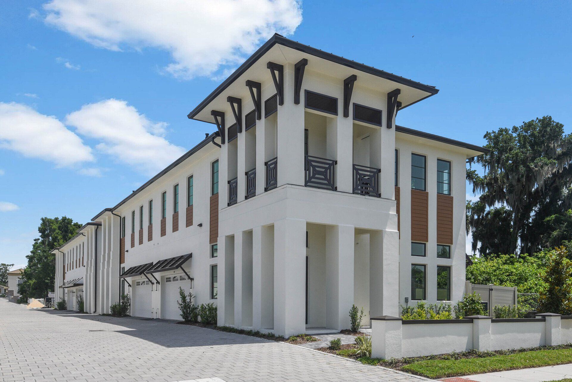 Vilasa Townhomes exterior with white siding, balconies, and manicured landscaping.