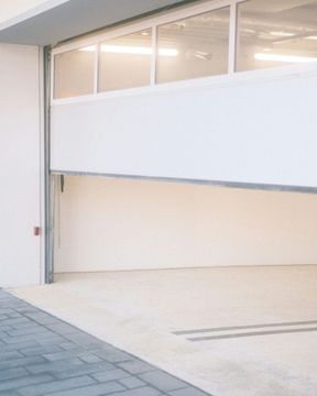 A white garage door with a lot of windows is open
