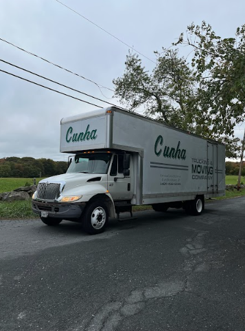 White Cacha delivery truck parked on a roadside under cloudy skies