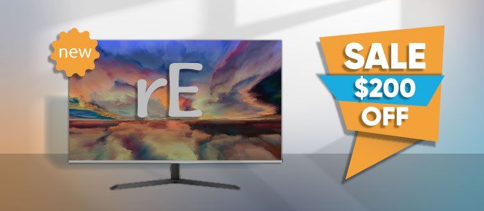 A computer monitor is sitting on a table next to a sign that says sale $ 200 off.