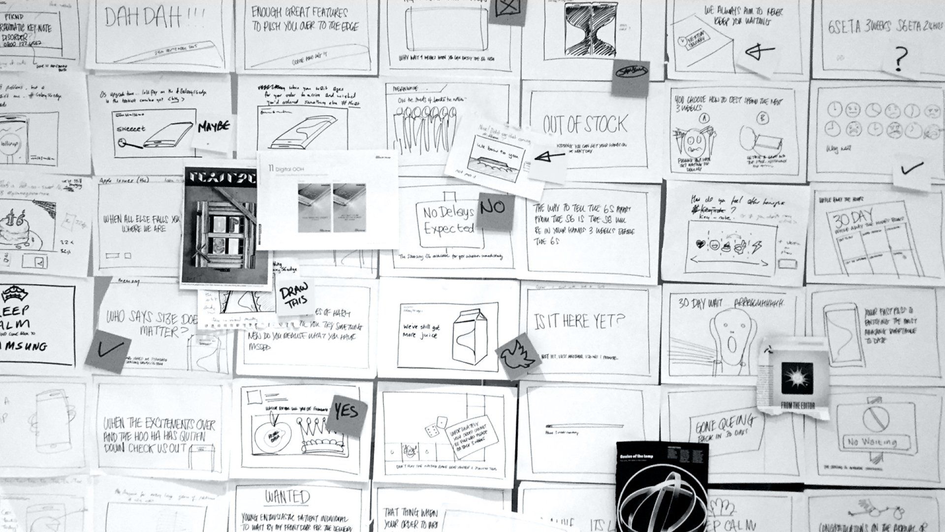 A wall filled with lots of drawings and notes on it.