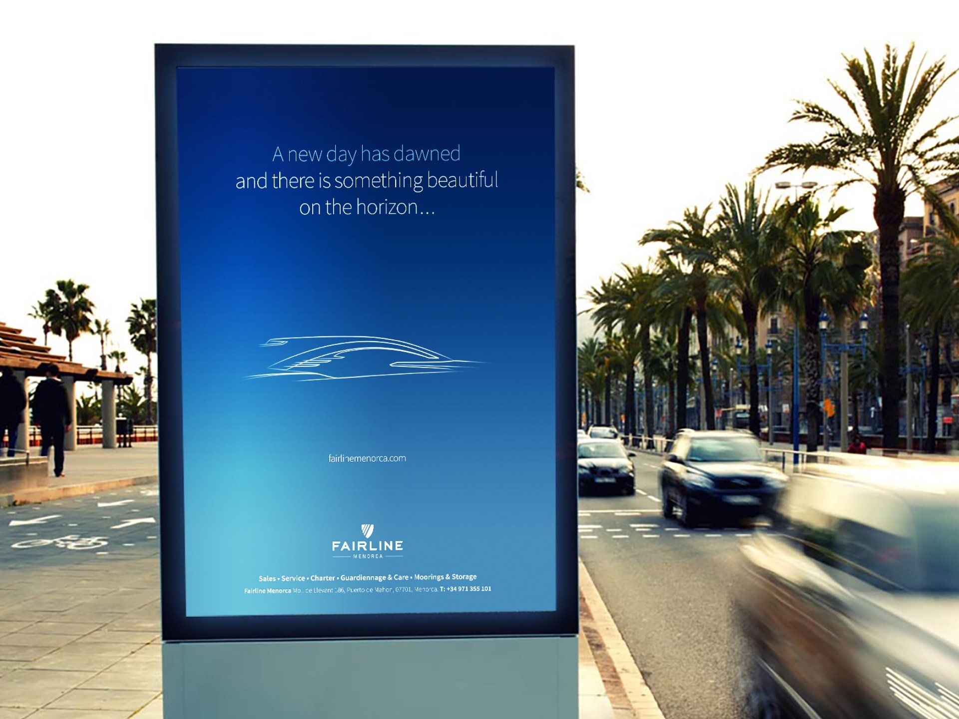 A billboard on the side of a street with cars driving by.