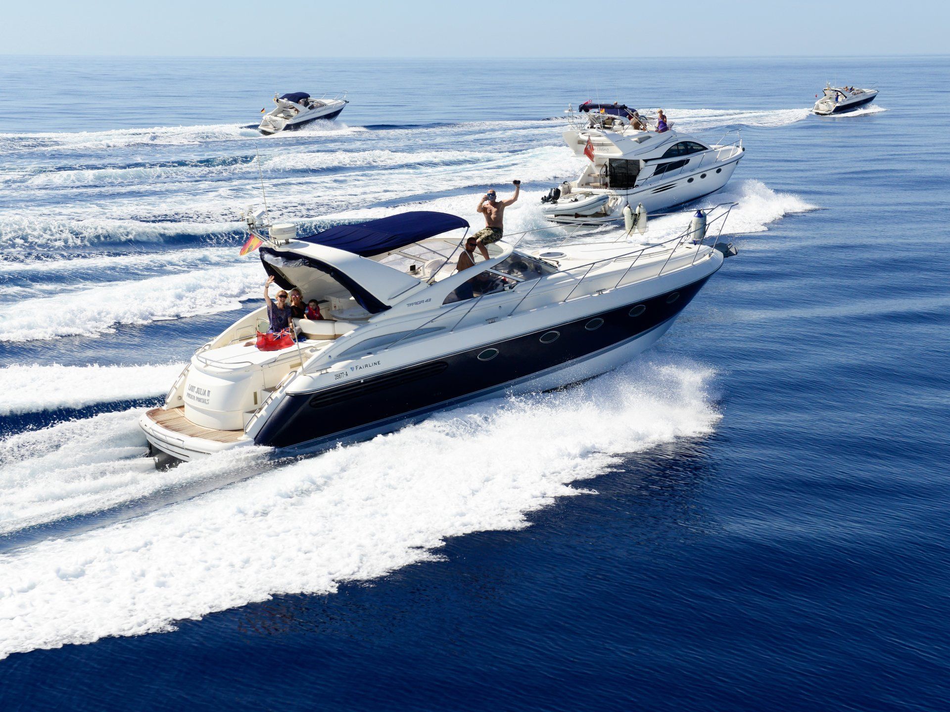 A group of boats are floating on top of a body of water
