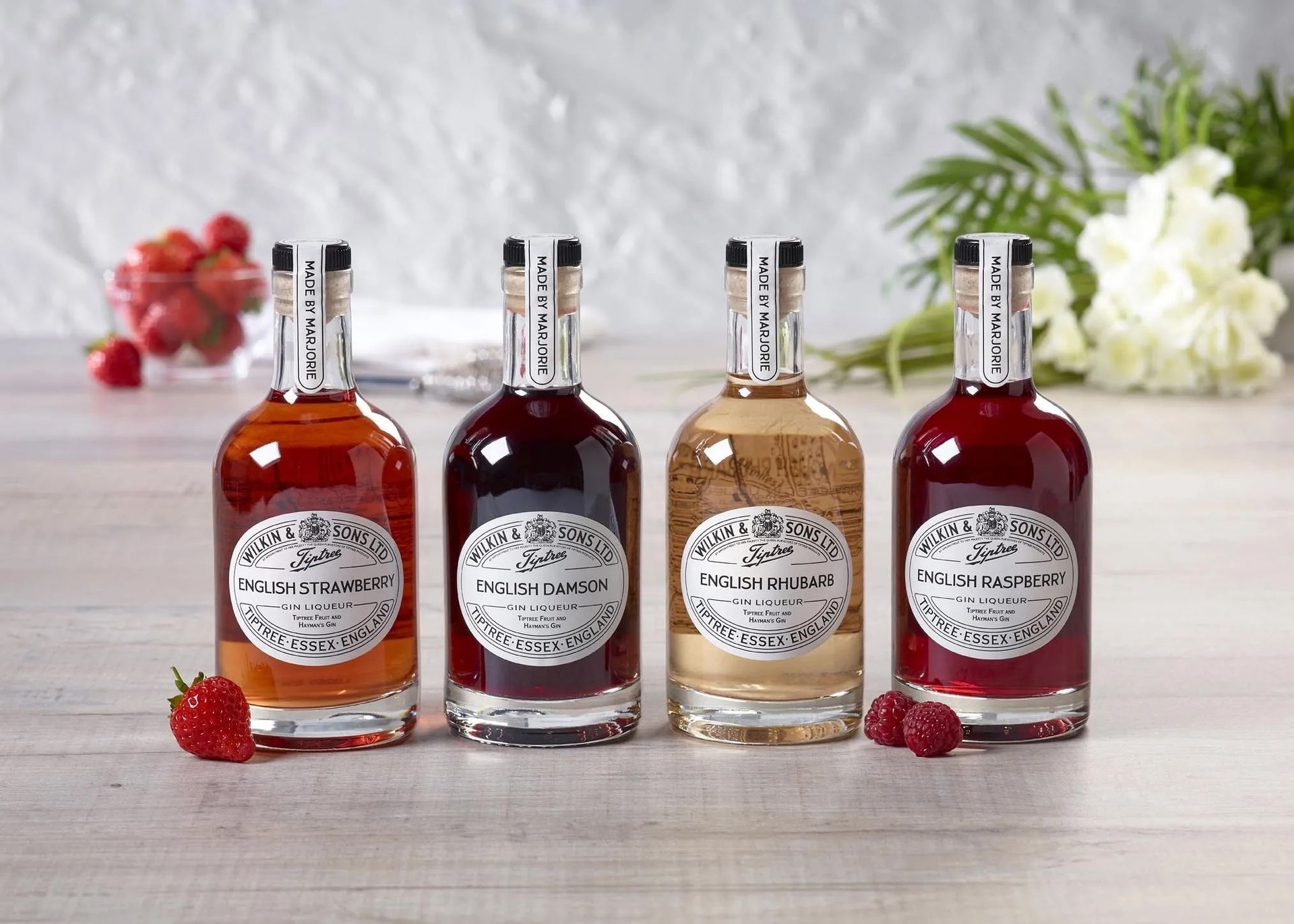 four bottles of liquor are lined up on a table .