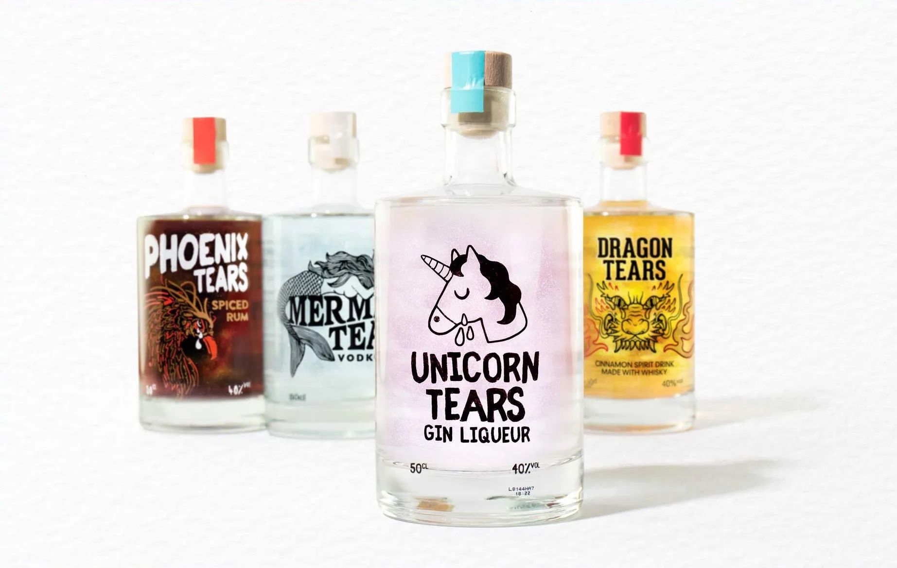 three bottles of alcohol are sitting next to each other on a table .