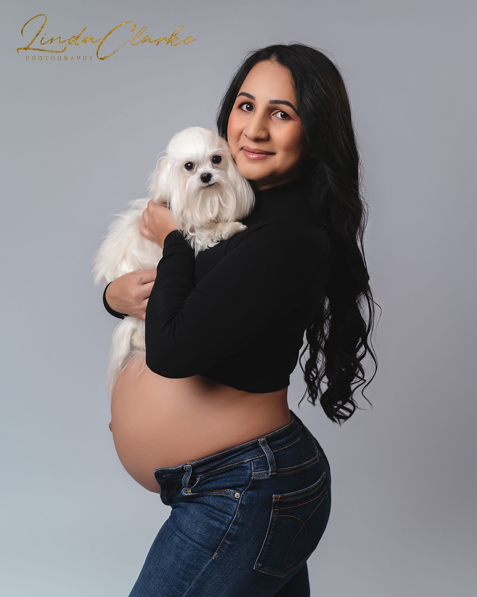 Pregnant woman holding a dog