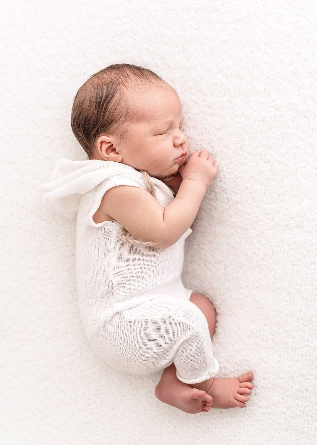 Parent review for Linda Clarke Photography alongside a timeless newborn portrait of a sleeping baby photographed in Linda's Dublin newborn photography studio.