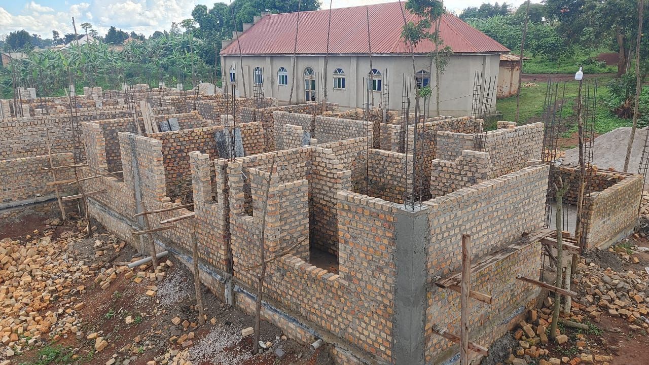 a building under construction with a building in the background