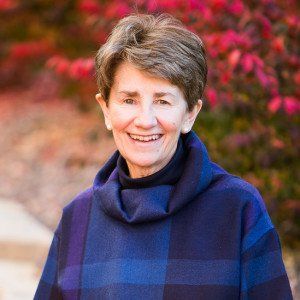 Woman in blue and purple plaid coat.