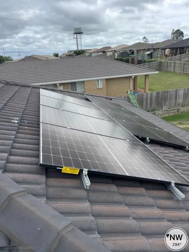 Solar Panels Installed on a Tiled Roof With Houses — KACE Electrical Solutions In Ramsay, QLD