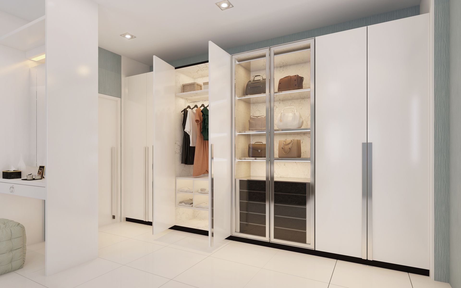A walk in closet with white cabinets and glass doors filled with clothes and handbags.