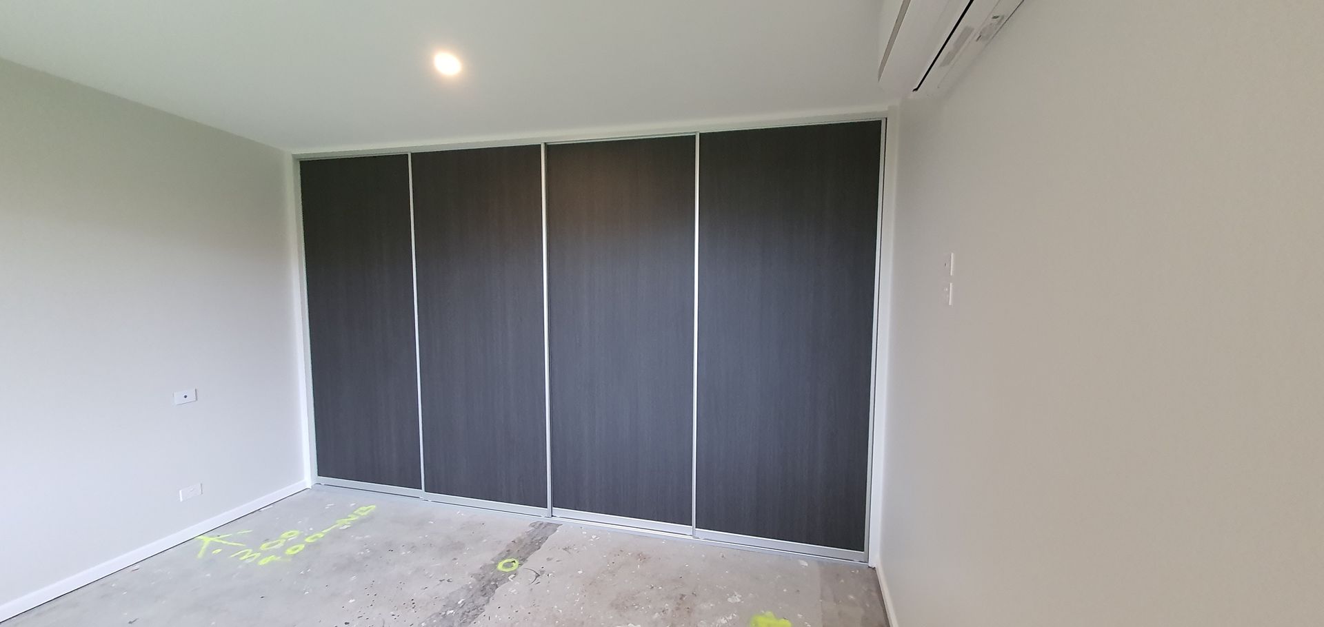 A room with a lot of sliding doors on the wall.