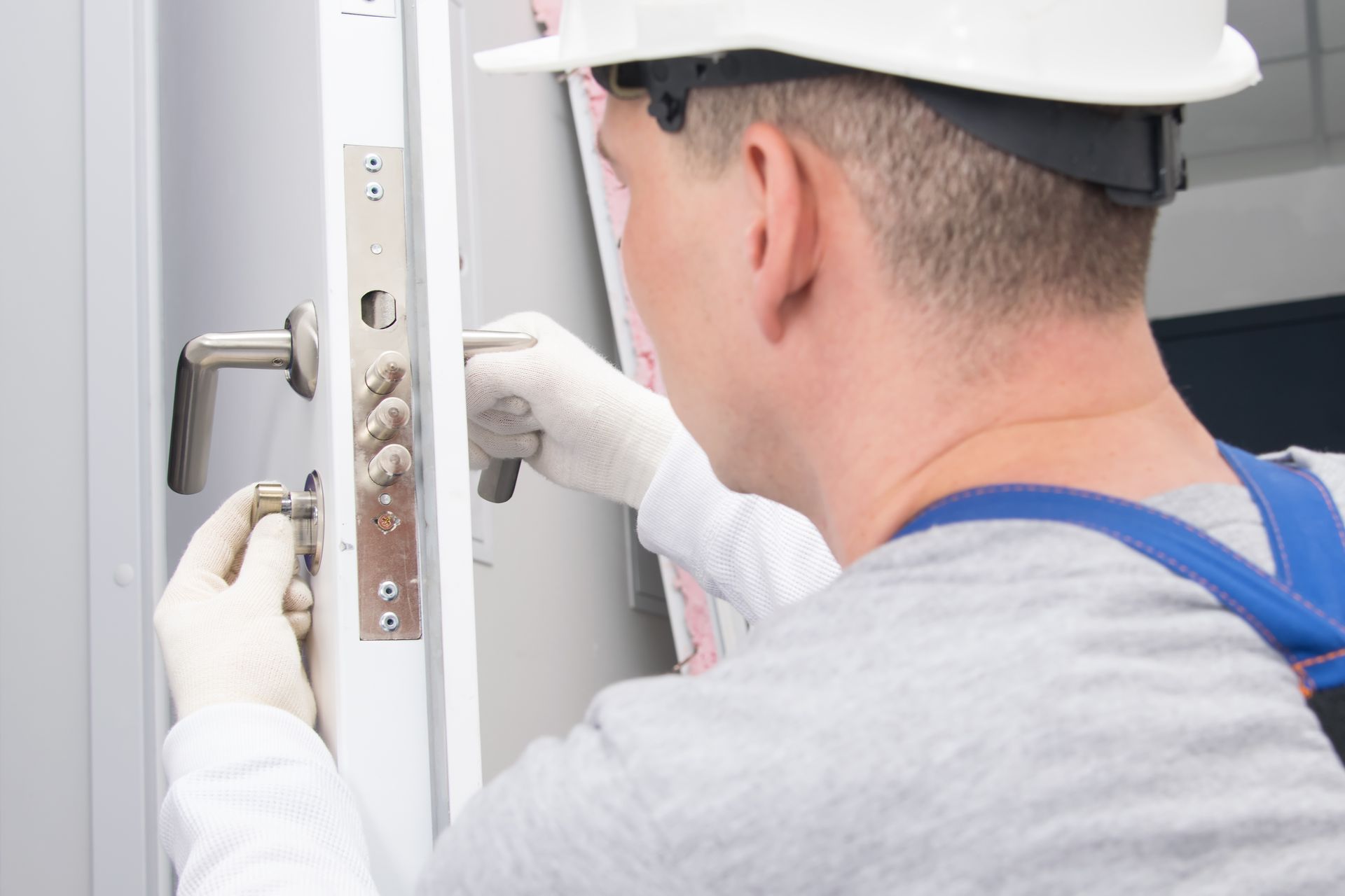 Lock replacement technician installing a new door lock