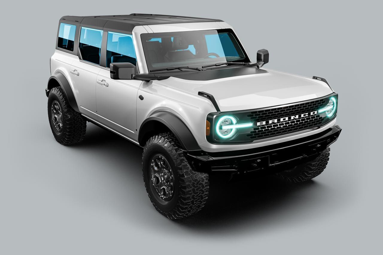 A white ford bronco is sitting on a gray surface.
