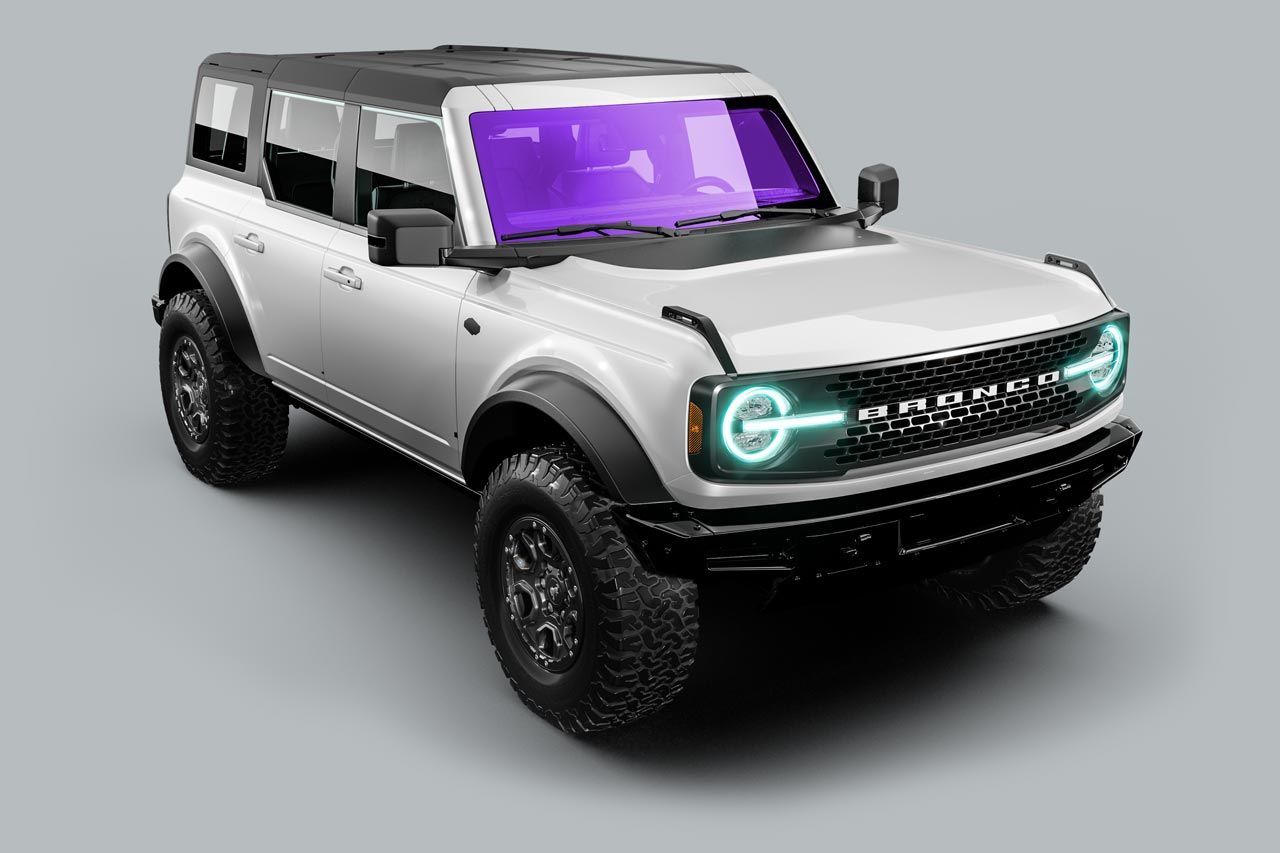A white ford bronco with a purple windshield is on a gray background.