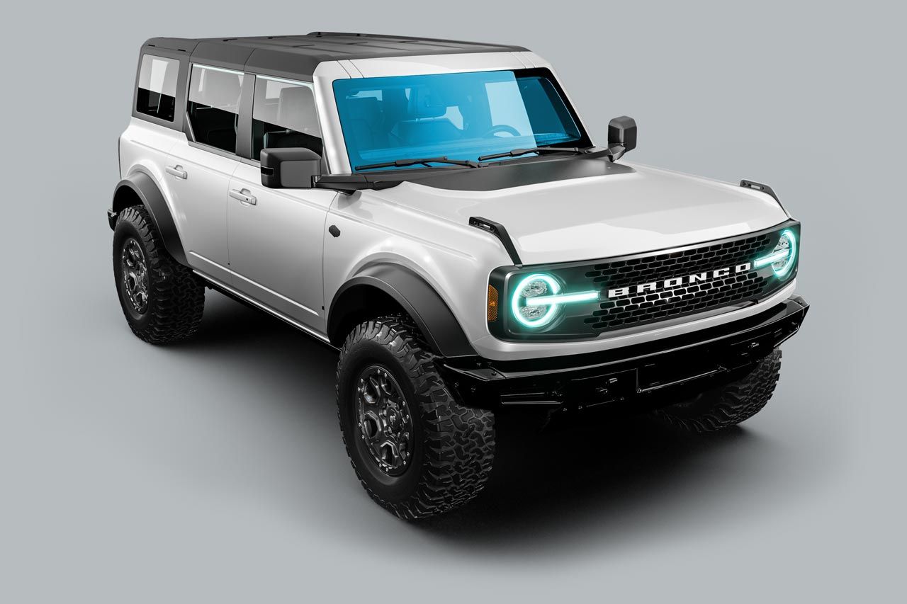 A white ford bronco is sitting on a gray surface.