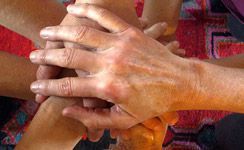 A group of people are stacking their hands on top of each other.