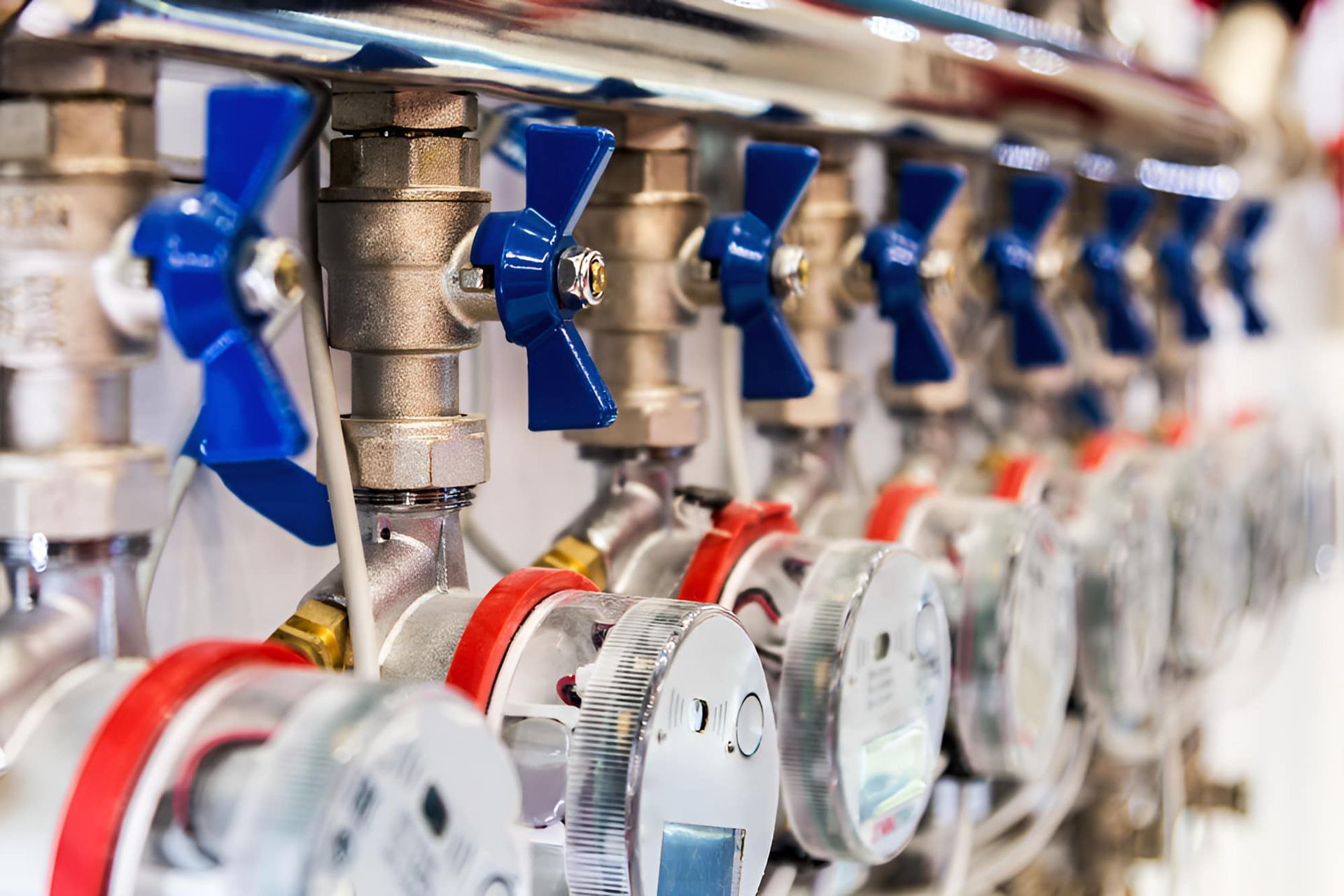A Row of Valves and Meters Are Lined Up in a Row — Simpson's Plumbing & Maintenance Service in Dakabin, QLD