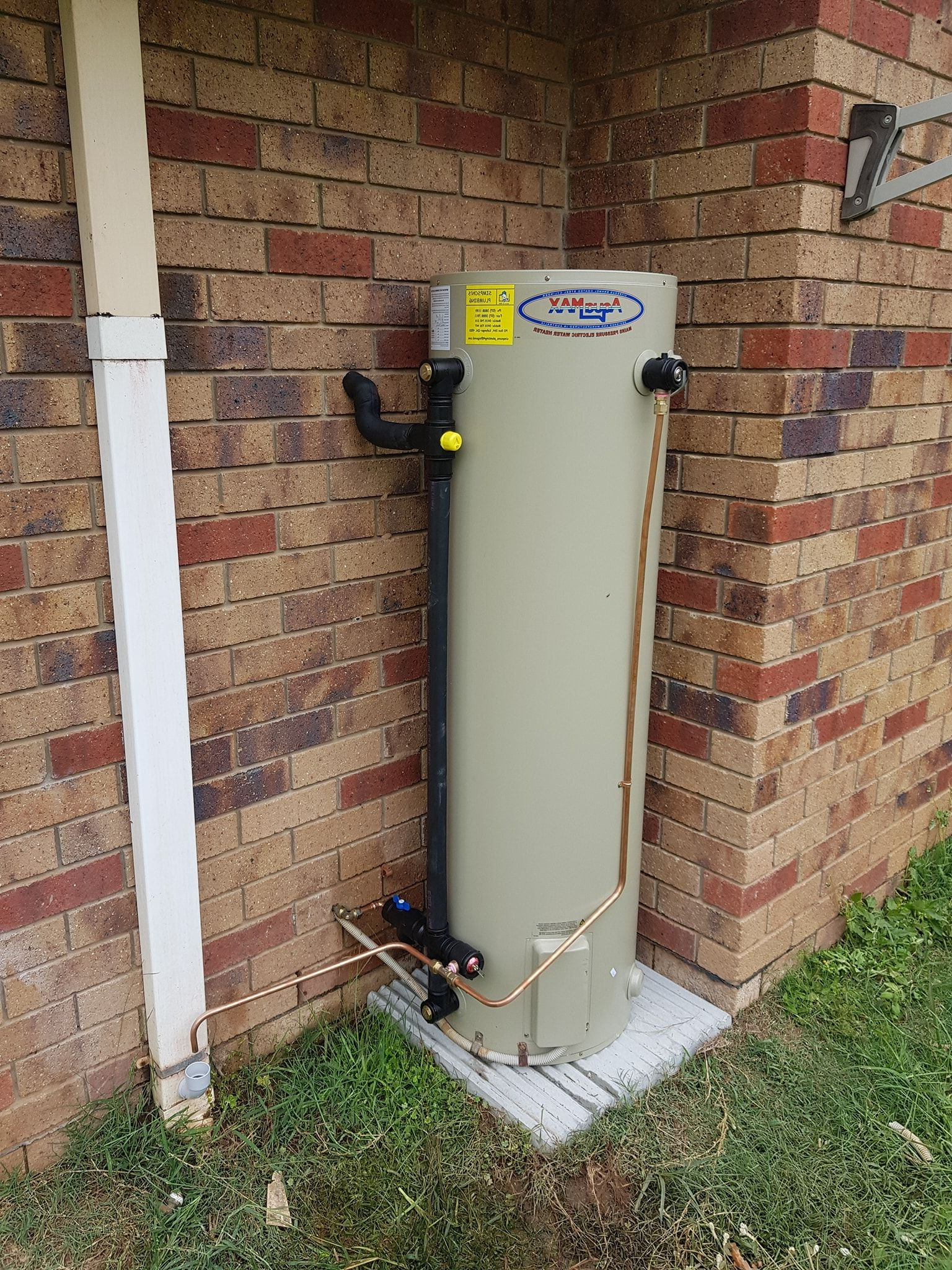 A Water Heater is Sitting in a Room Next to a Boiler — Simpson's Plumbing & Maintenance Service in Dakabin, QLD